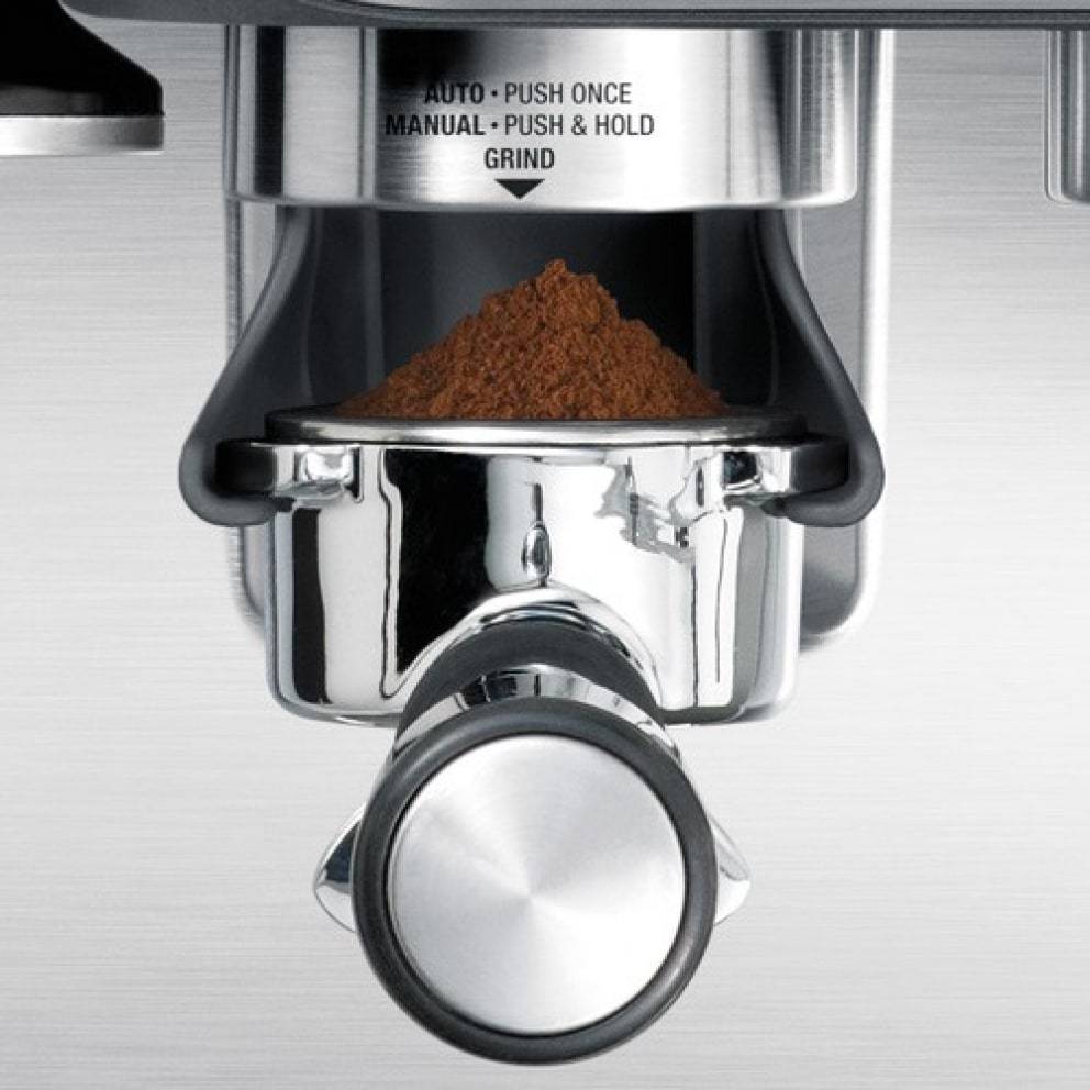 Steam wand creating microfoam milk for latte art on the Barista Express.