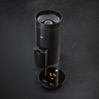 Perfectly Brewed Coffee - A close-up of freshly brewed coffee in a cup with the Wilfa coffee maker in the background. black